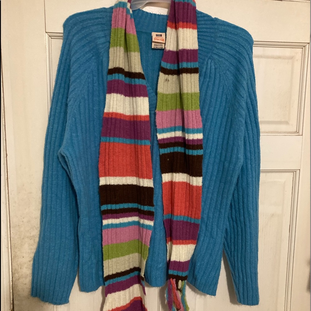 Acrylic blue sweater with contrasting scarf.